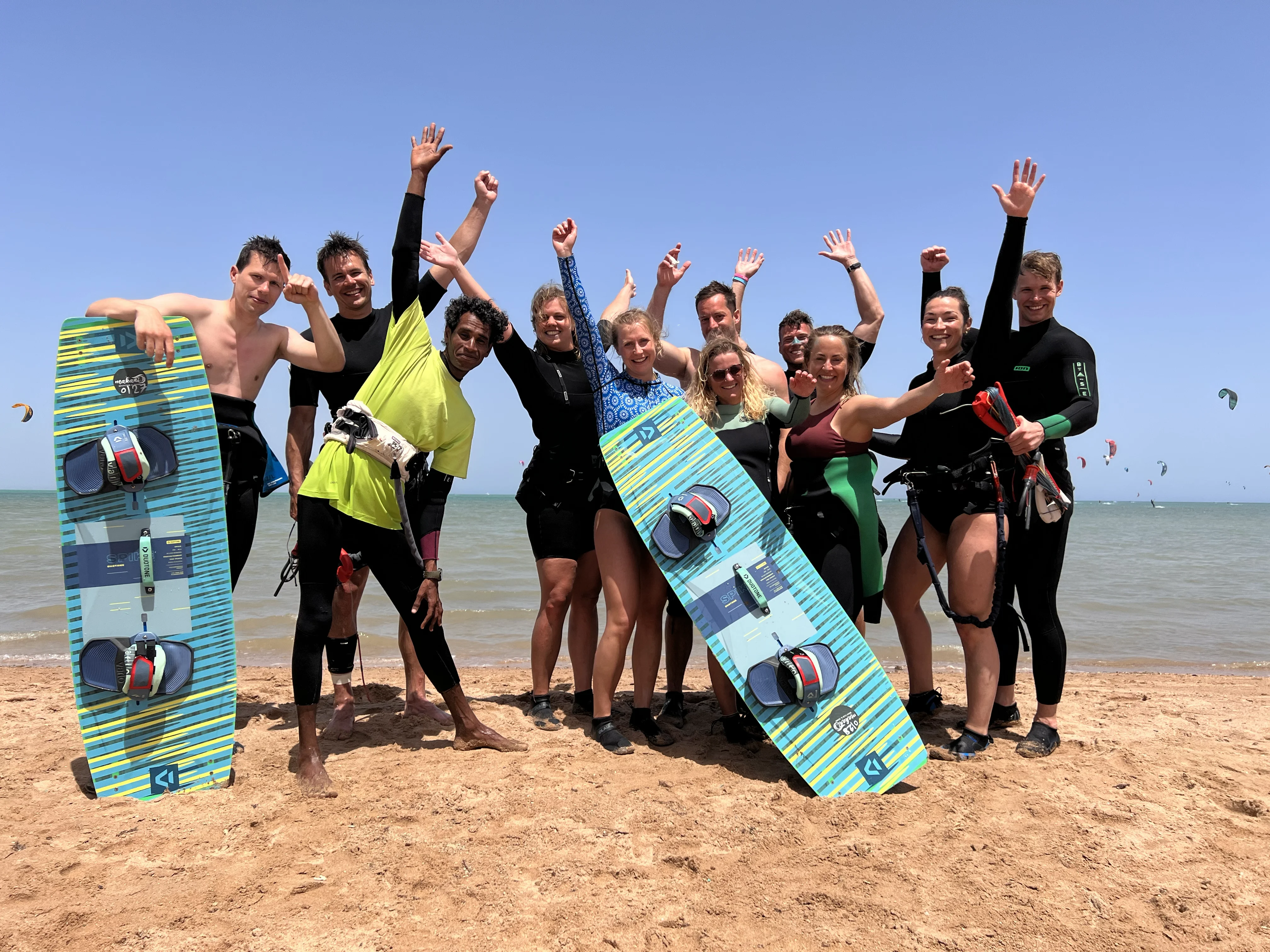 Kitesurfing camp with people learning and riding kites